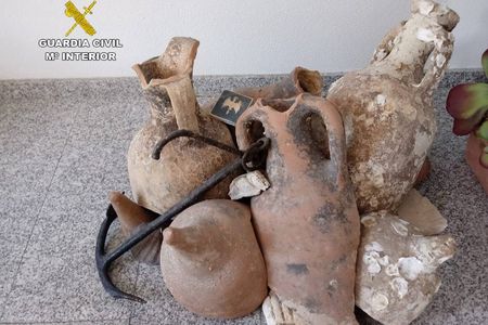 Police discovered a total of 13 Roman amphorae and an 18th-century anchor inside a frozen seafood shop in Alicante, Spain.