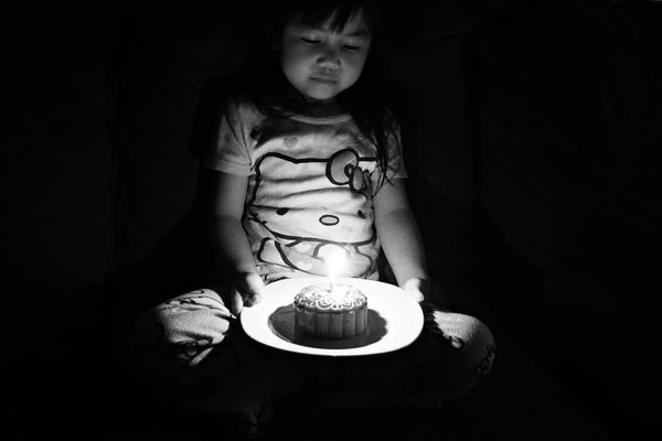 A child celebrating her lunar birthday with mooncake thumbnail