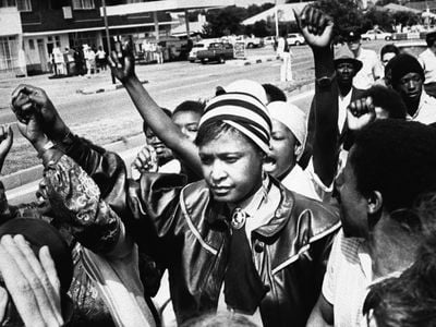 Winnie Mandela is cheered by supporters after appearing in the Krugersdorp Magistrate's court in connection with her arrest for flouting a banning order which prevents her from living in her Soweto home West of Johannesburg on Jan. 22, 1986.