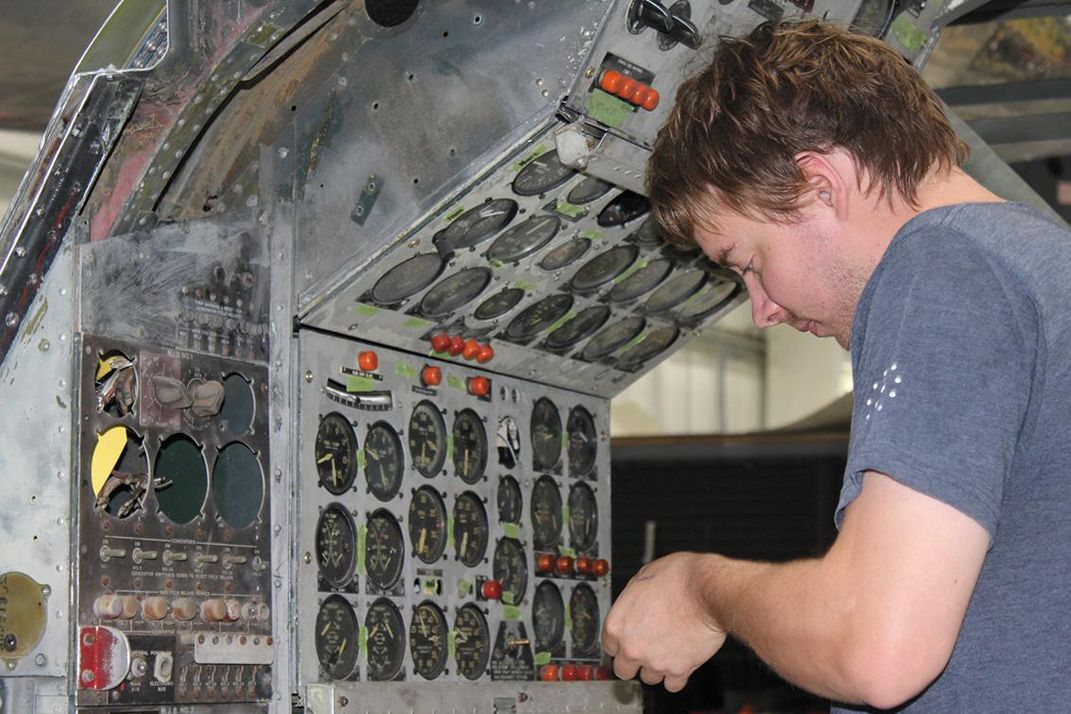 	Aaron Ascheexamines the flight engineer’s instrument panel. 