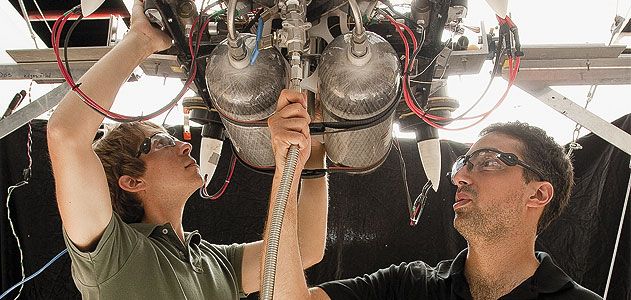 Draper Lab team members Bobby Cohanim (in black shirt) and Eph Lanford check fittings and connections on TALARIS before running a test.