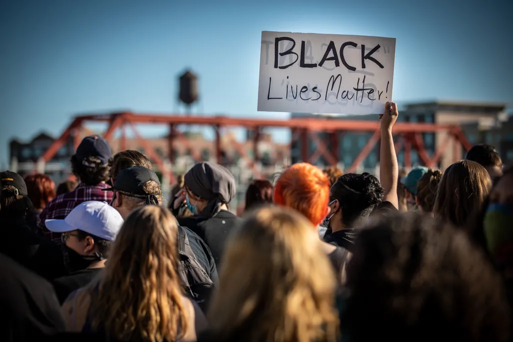 Group of protesters during black lives matter marches holding a black lives matter sign
