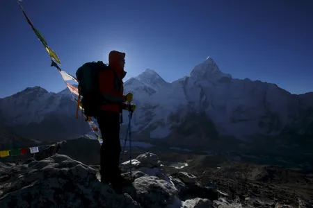 A climber stands in front of Mount Everest at Kala Patthar in Solukhumbu District of Nepal
