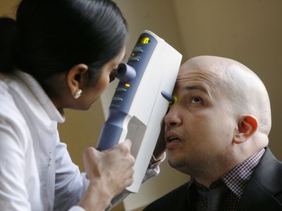 A doctor administers a common glaucoma test. 