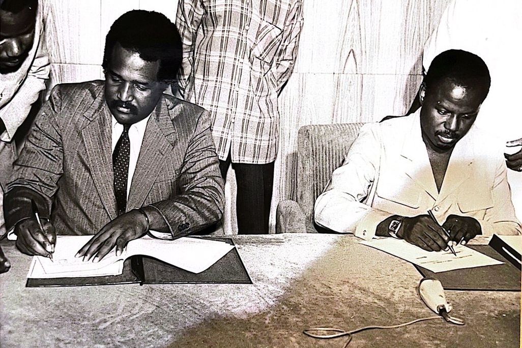 John H. Smith signs a document