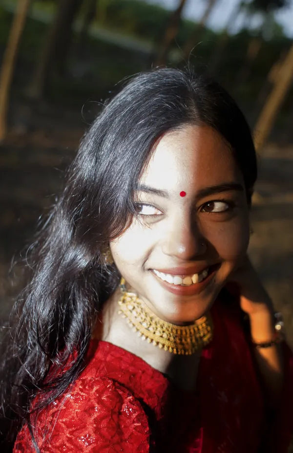 A smile illuminated by the dance of late afternoon light and flashlight thumbnail