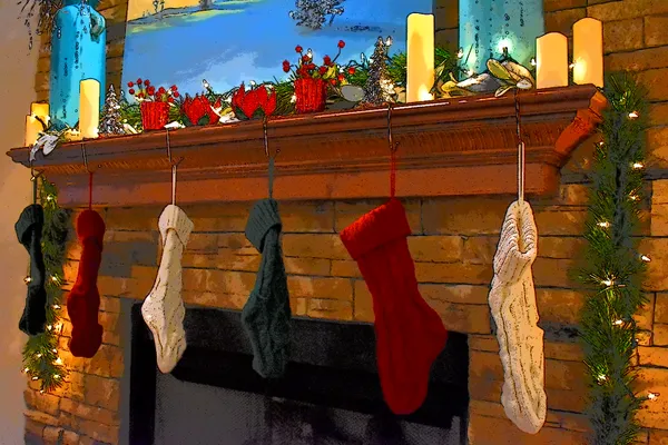 Stockings hanging from a festive mantle. thumbnail