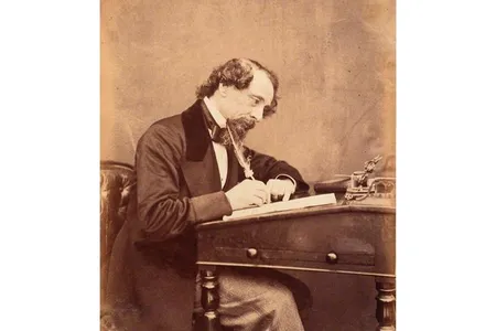 Charles Dickens, seen at his desk in 1858