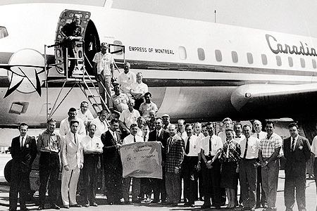 It takes a village to reach Mach 1.01. The flight and ground crews for the DC-8 supersonic run included flight test engineer Richard H. Edwards, third from left, and pilot Bill Magruder, in white shirt behind sign.