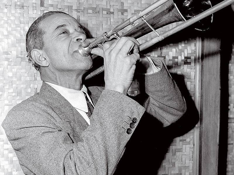 Kid Ory plays the trombone.