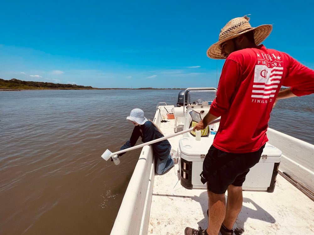 People collecting water samples from a boat