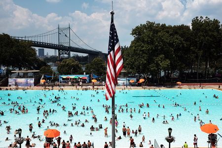 People enjoy a hot afternoon at the Astoria Pool in the borough of Queens on August 17, 2015, in New York City.