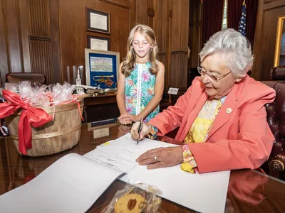 Alabama Governor Kay Ivey with Mary Claire Cook, a fourth-grade student and creator of the new cookie