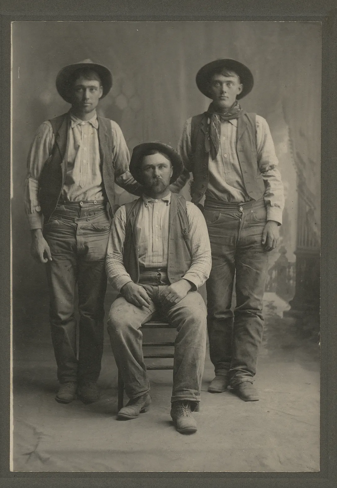 A trio of miners wearing blue jeans