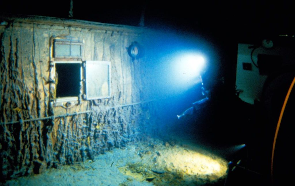 a light shines on a disintegrating ship