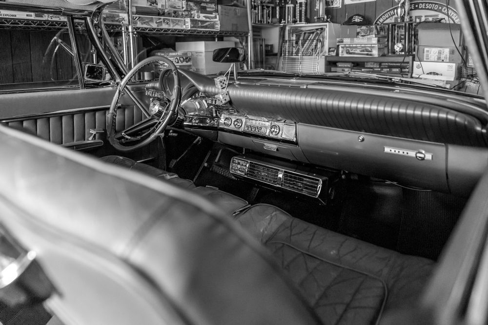 This is the interior of a 1962 Chrysler 300 parked in a garage. My father in law has owned this car for several decades and has put in many different car shows all over where it has won several trophies. The car has a unique look both inside and out. This was a time when American cars had character. He has spent years taking care of this car and I have always loved to photograph it.