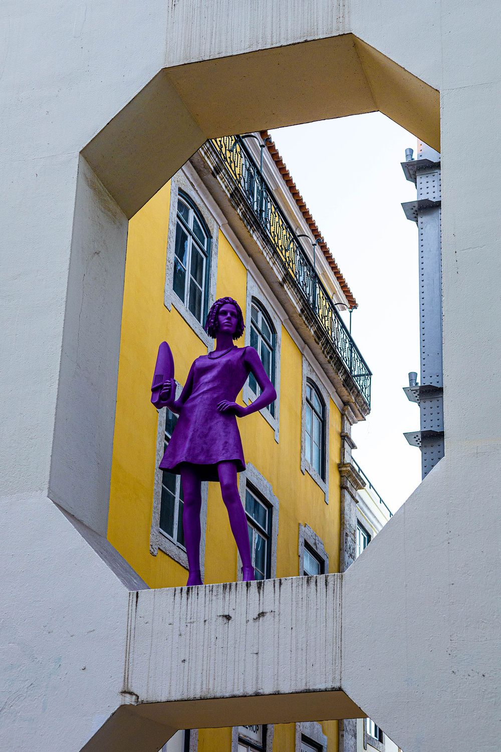 Purple woman statue in downtown Lisbon.