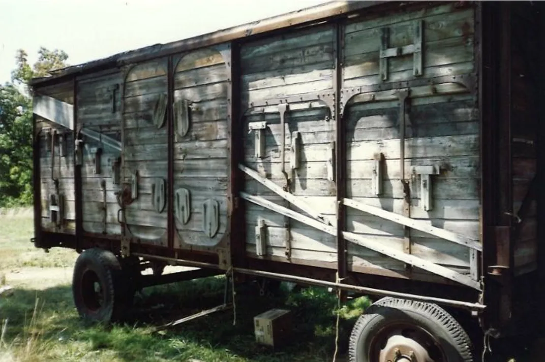 Old boxcar in a field on top of grass