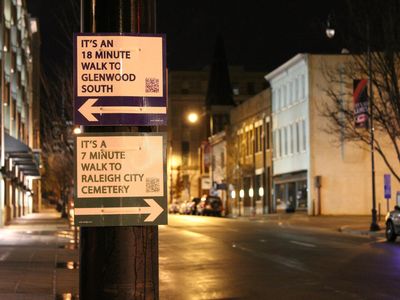 Signs with arrows pointing the way to popular destinations, along with average walking times, popped up in Raleigh.