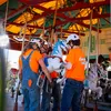 Workers install a horse in the refurbished Smithsonian carousel