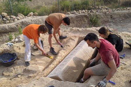 The coffin is adorned with geometric patterns and interlocking ivy leaves.