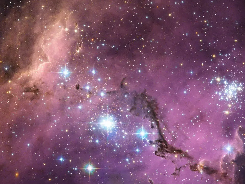 The Large Magellanic Cloud floats in space, in a long and slow dance around our galaxy. Vast clouds of gas within it slowly collapse to form new stars. In turn, these light up the gas clouds in a riot of colors.