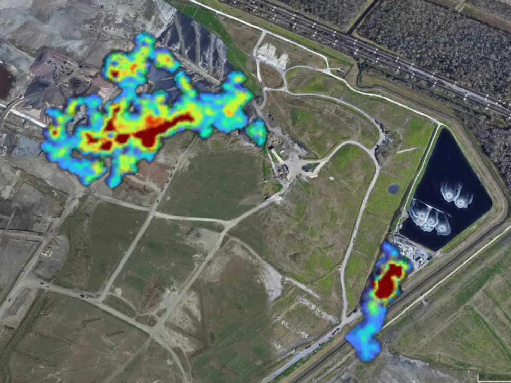 An aerial image of a landfill with a heat map showing methane emissions