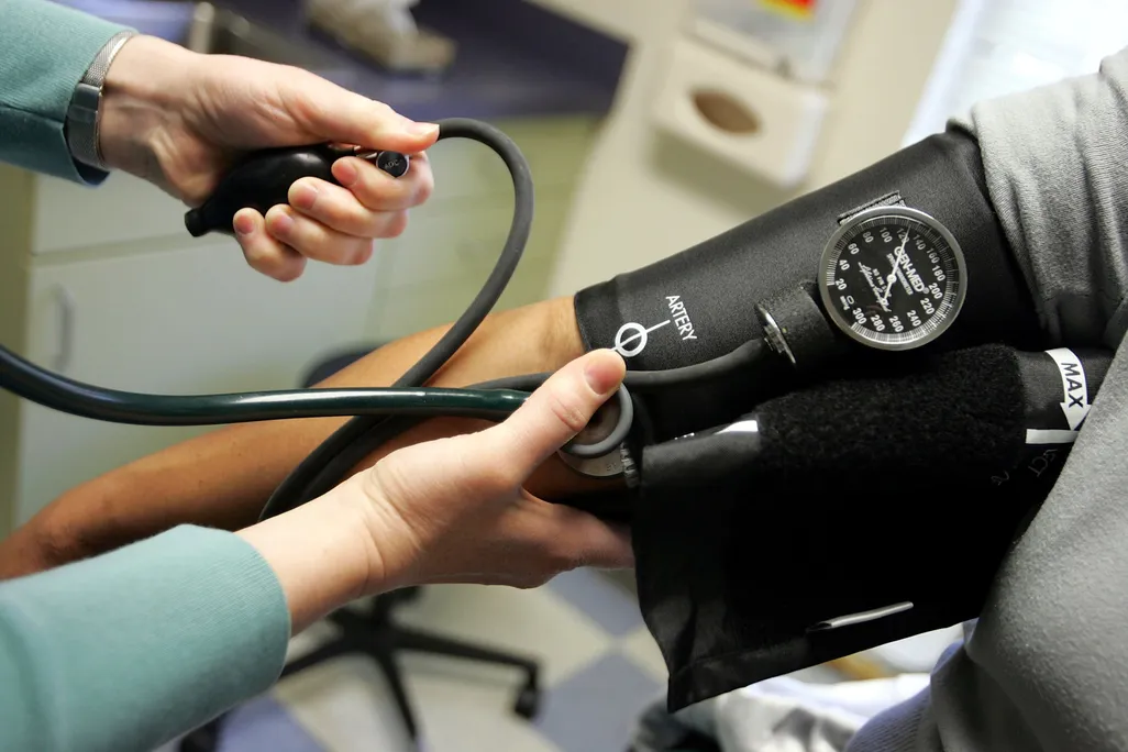 A person gets their blood pressure measured