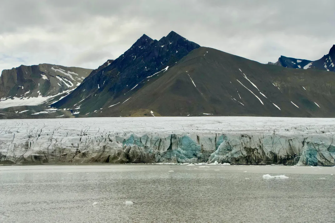glaciers and dark mountains behind the ocean