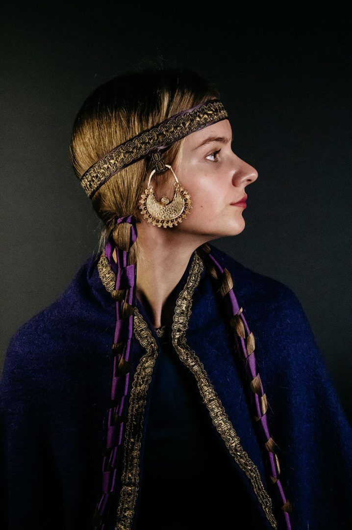 Profile of blonde woman wearing large gold earring