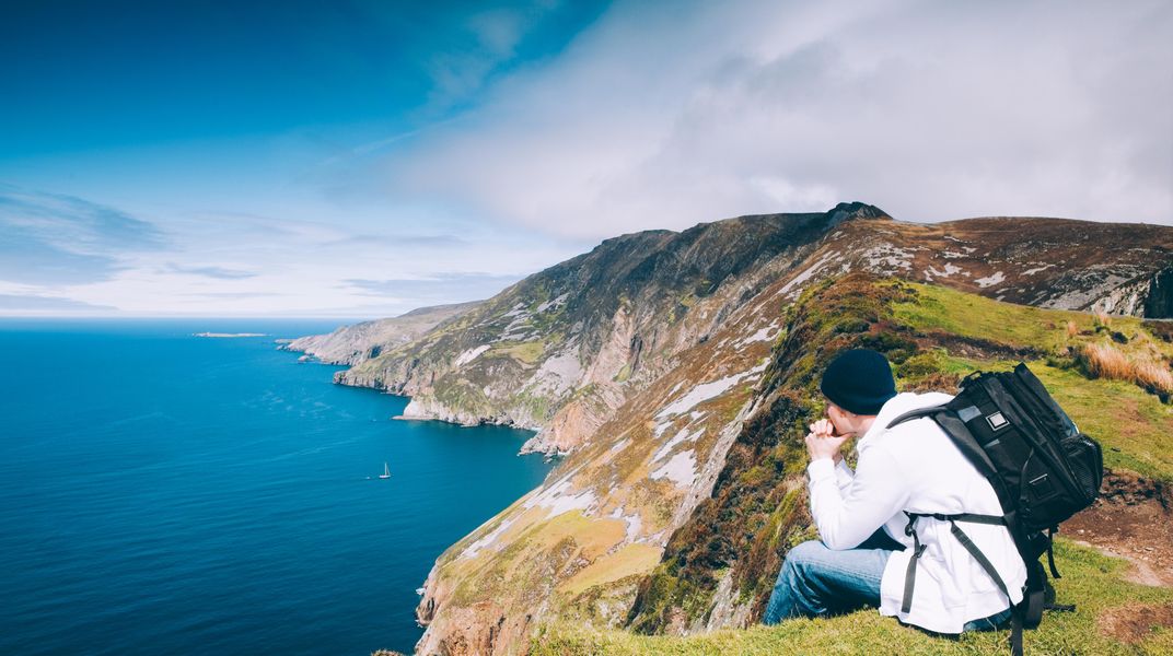 Hiker overlooking the Irish coast