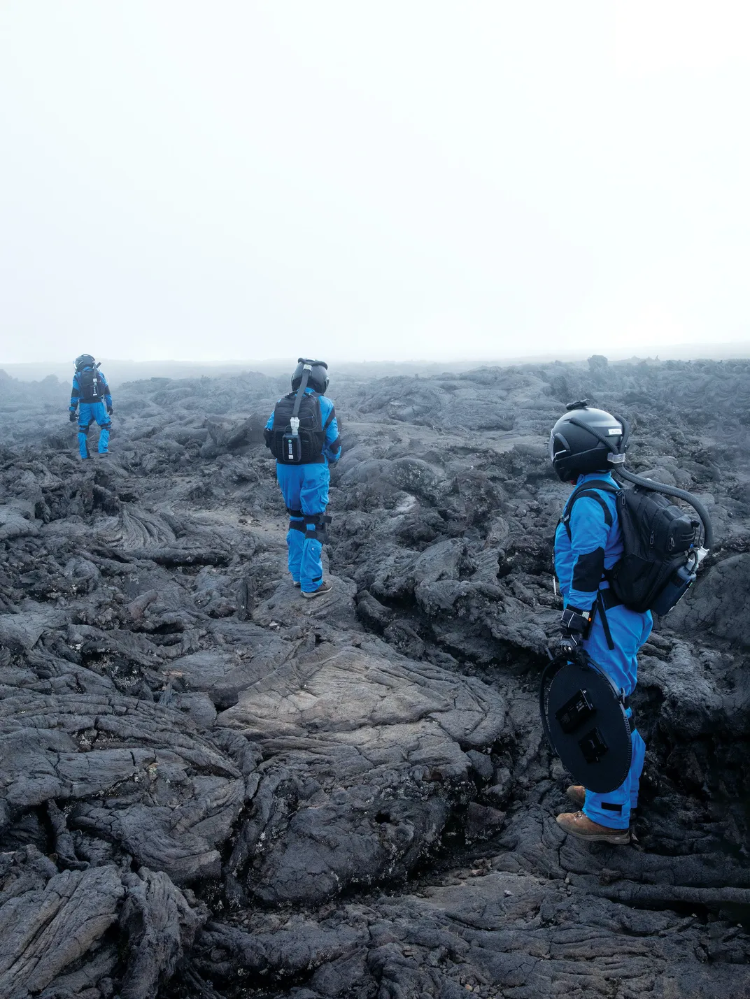 crew members stand on magma rock