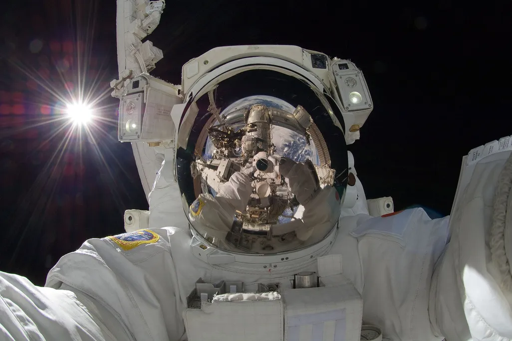 astronaut taking a selfie in space suit