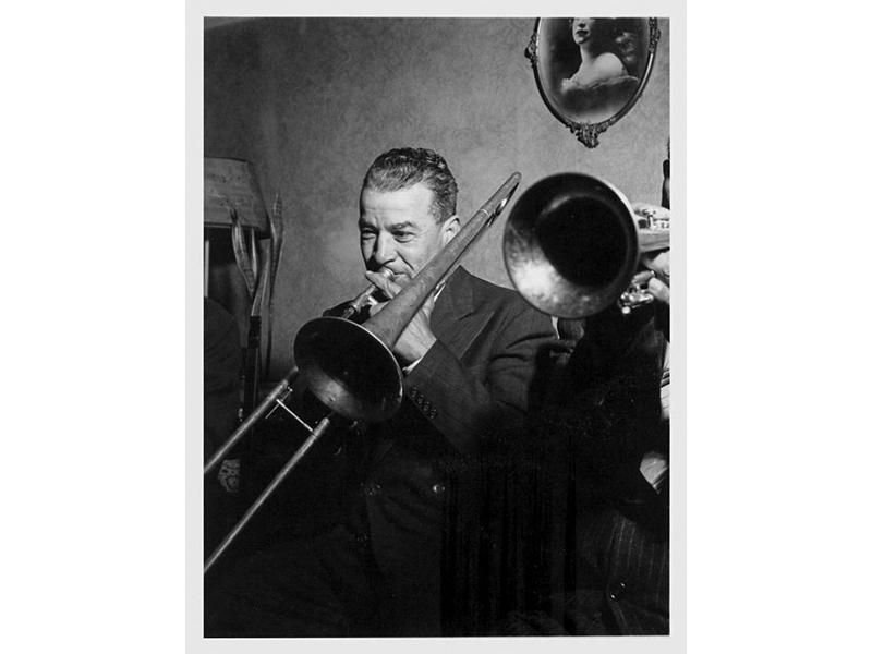 Kid Ory plays the trombone.