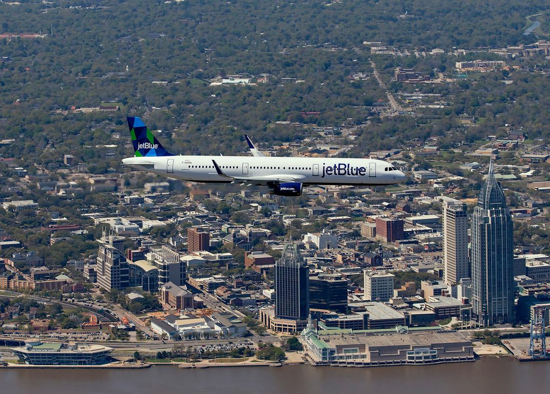 The A321 soars over a Mobile skyline