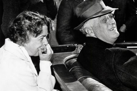 Eleanor Roosevelt leans forward from the back seat of the Roosevelt car to catch a comment from her husband, Franklin, as they campaign for his fourth term as president. 