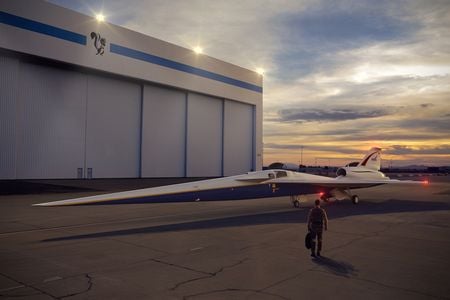 An artist’s concept of the low-boom flight demonstrator outside the Lockheed Martin Aeronautics Company’s Skunk Works hangar in Palmdale, California.