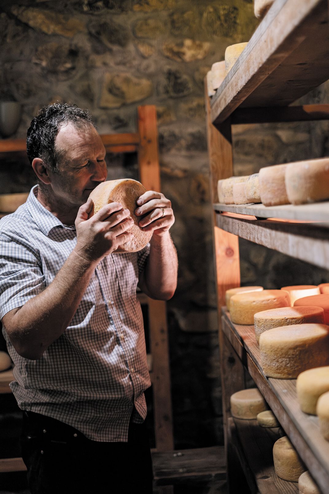 Klemen Matk uses his well-trained nose to check on the aging process in his cheese cellar.