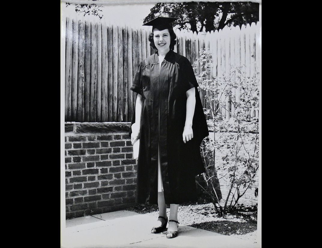 Black and white photo of Crimilda Pontes in graduation gown.