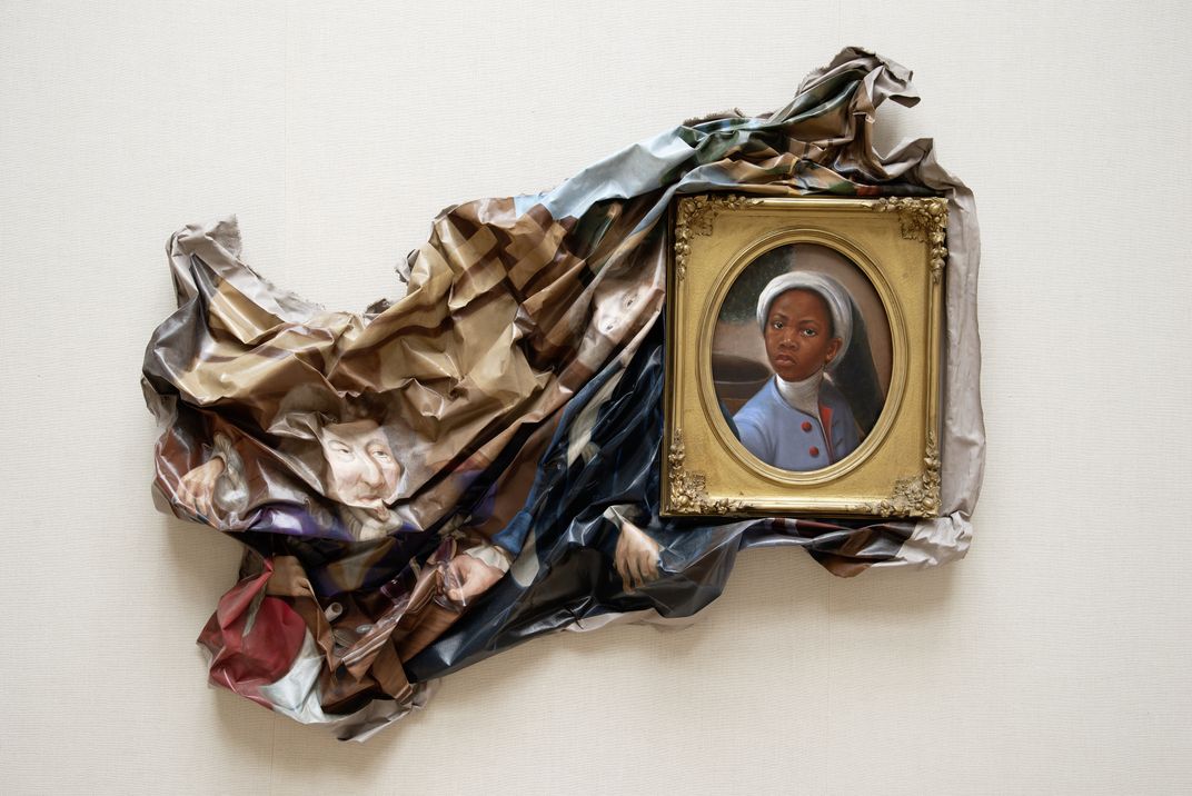 A traditional canvas has been crumpled and warped, except for the small face of a young Black boy who stares at the viewer, surrounded by a golden frame