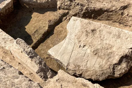 Researchers found the stone slab broken and buried in an ancient throne room.