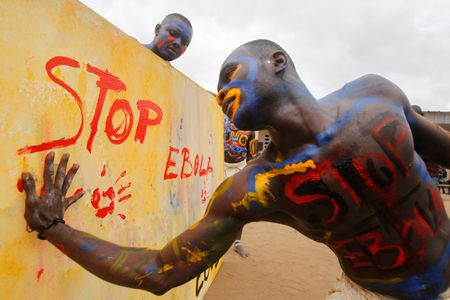 An actor, playing the role of a vaccine against Ebola, performs at a school in Abidja, Ivory Coast, last September
