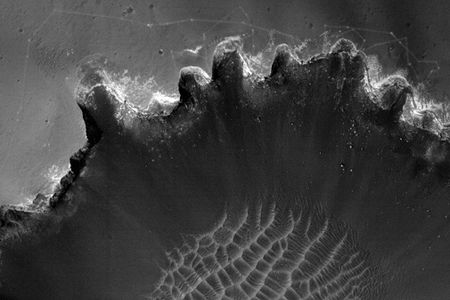 The Opportunity Mars rover prepares to descend into a deep crater.