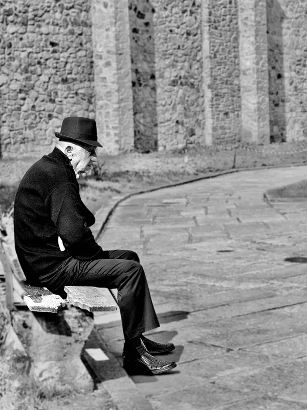 Old man resting on a bench thumbnail