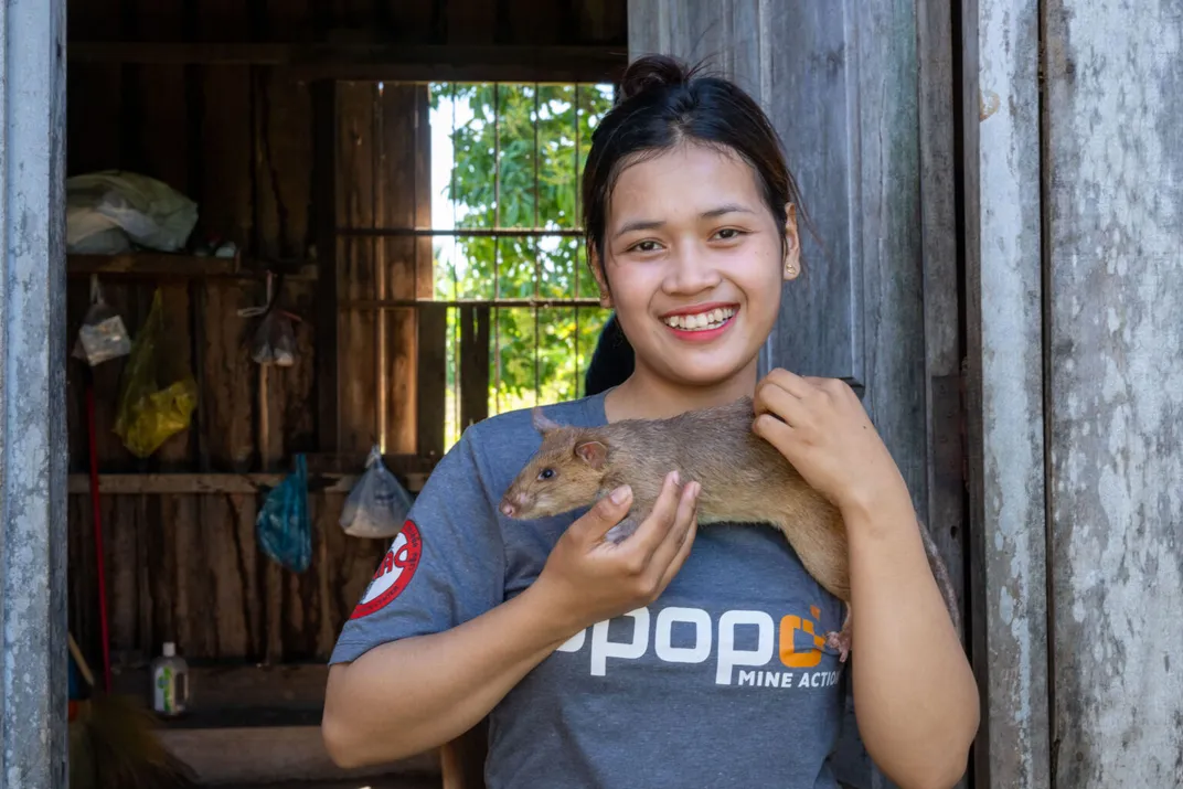 Woman smiling and holding a large rat