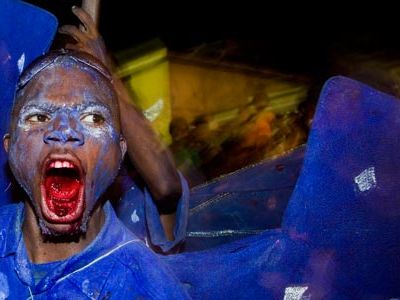 Partaking in an old but ambiguous rite, blue "devils" (in Paramin, with mouths colored by dyed bubble gum) offer spectators a deal: pay, or get rubbed with body paint.