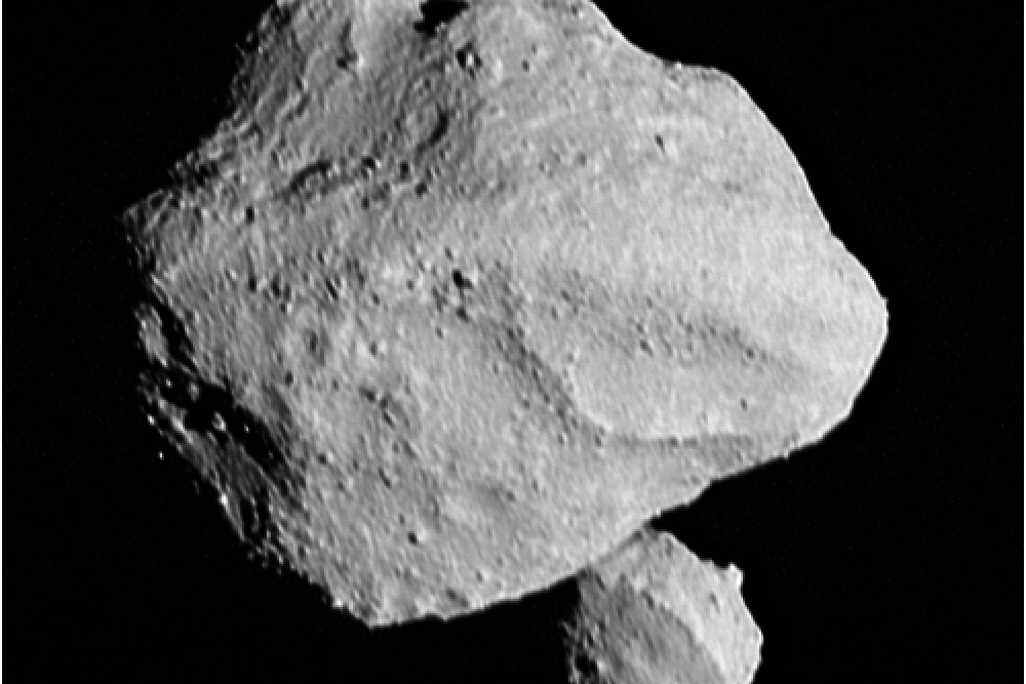 A black and white photo of an asteroid with a second smaller asteroid below and behind it