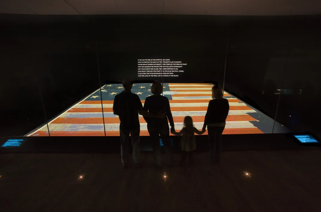 A family viewing the Star-Spangled Banner at the National Museum of American History in Washington, D.C.