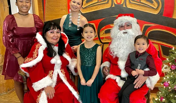 Indigenous family surrounding Santa Claus