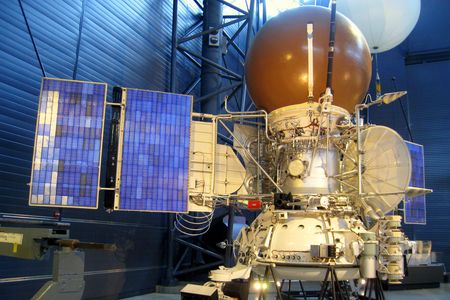 A model of the Soviet VEGA Venus spacecraft, with the white atmospheric balloon peeking out from behind.